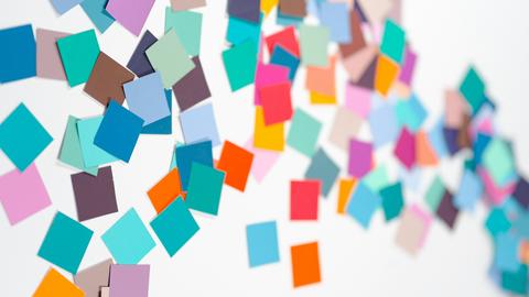 scattered post its across a board