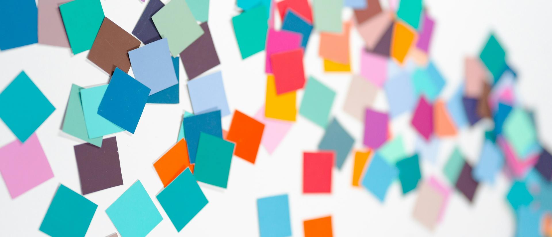 scattered post its across a board